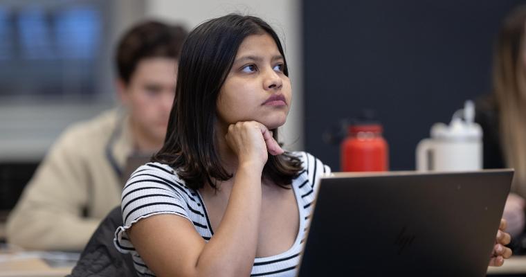 Leavey student with laptop focused in class