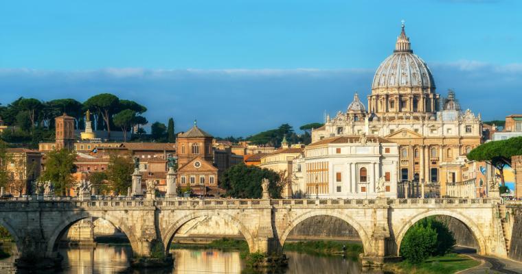 Rome Skyline with Vatican St Peter Basilica of Vatican and St Angelo Bridge crossing Tiber River in the city center of Rome Italy.