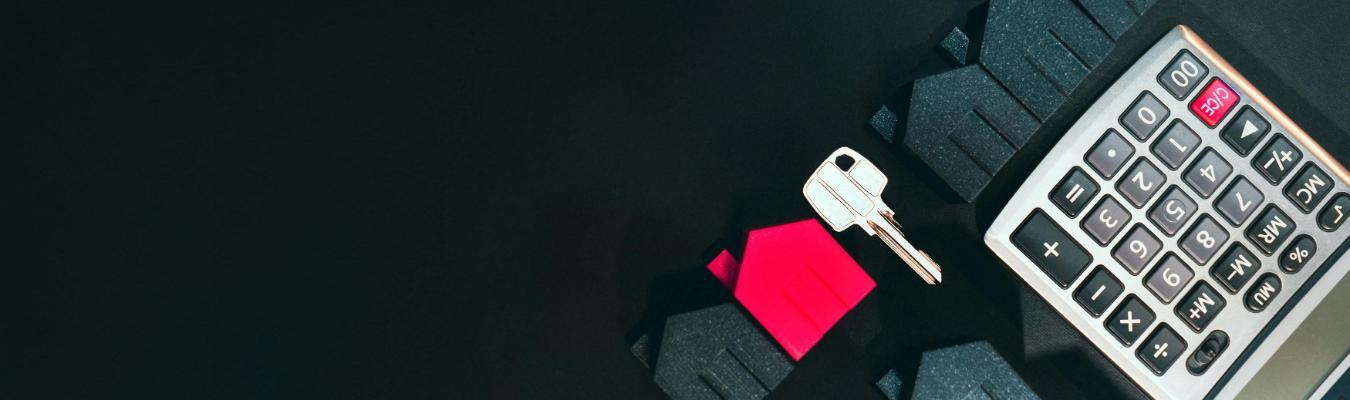 House-shaped models, a house key, and calculator