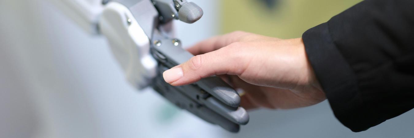 Human and robot handshake closeup
