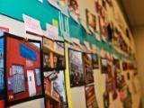 A wall covered with colorful maps, photos, and notes.
