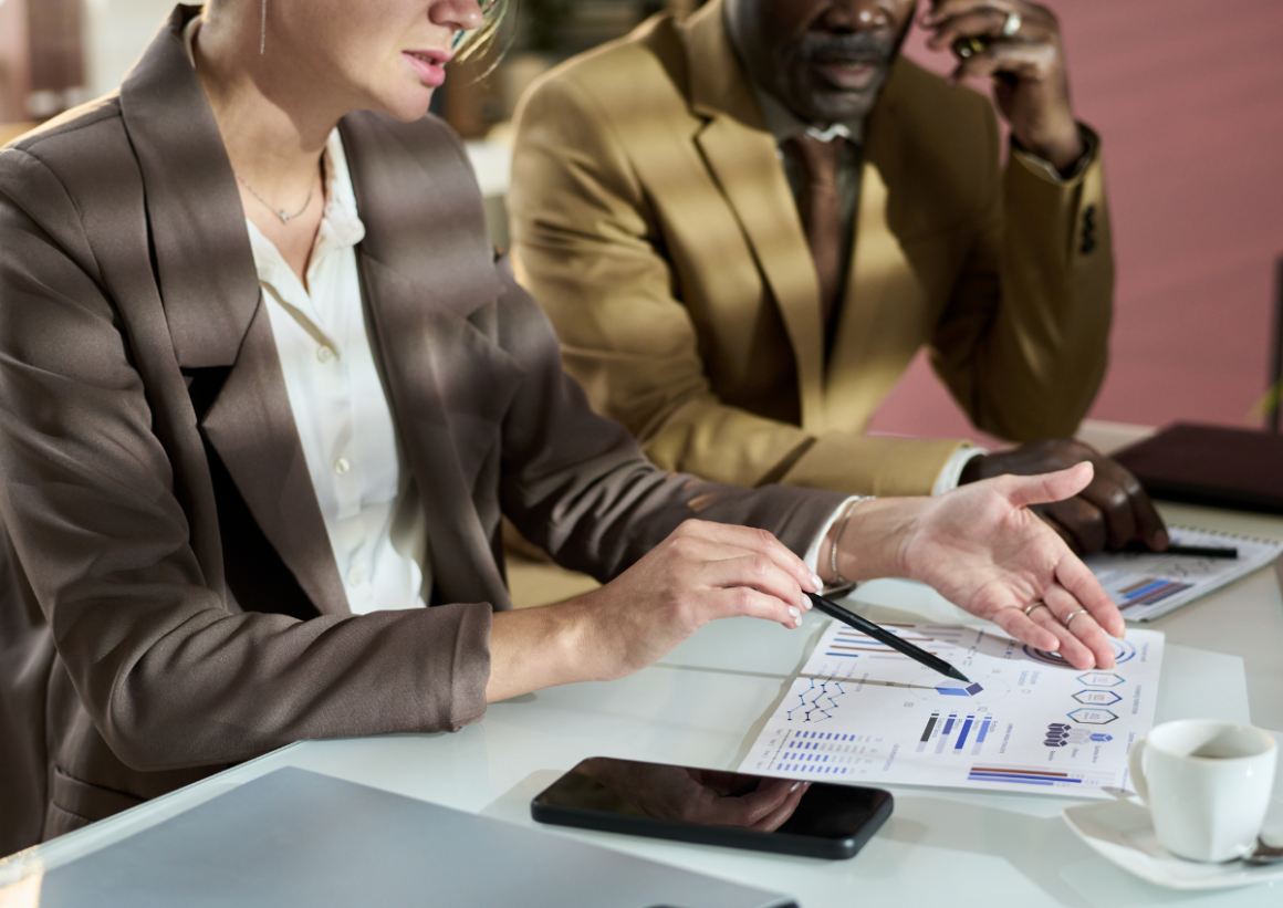 Business professionals in suits working together to understand charts