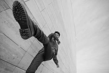 Person lying on stairs with one leg and foot prominent in the foreground.