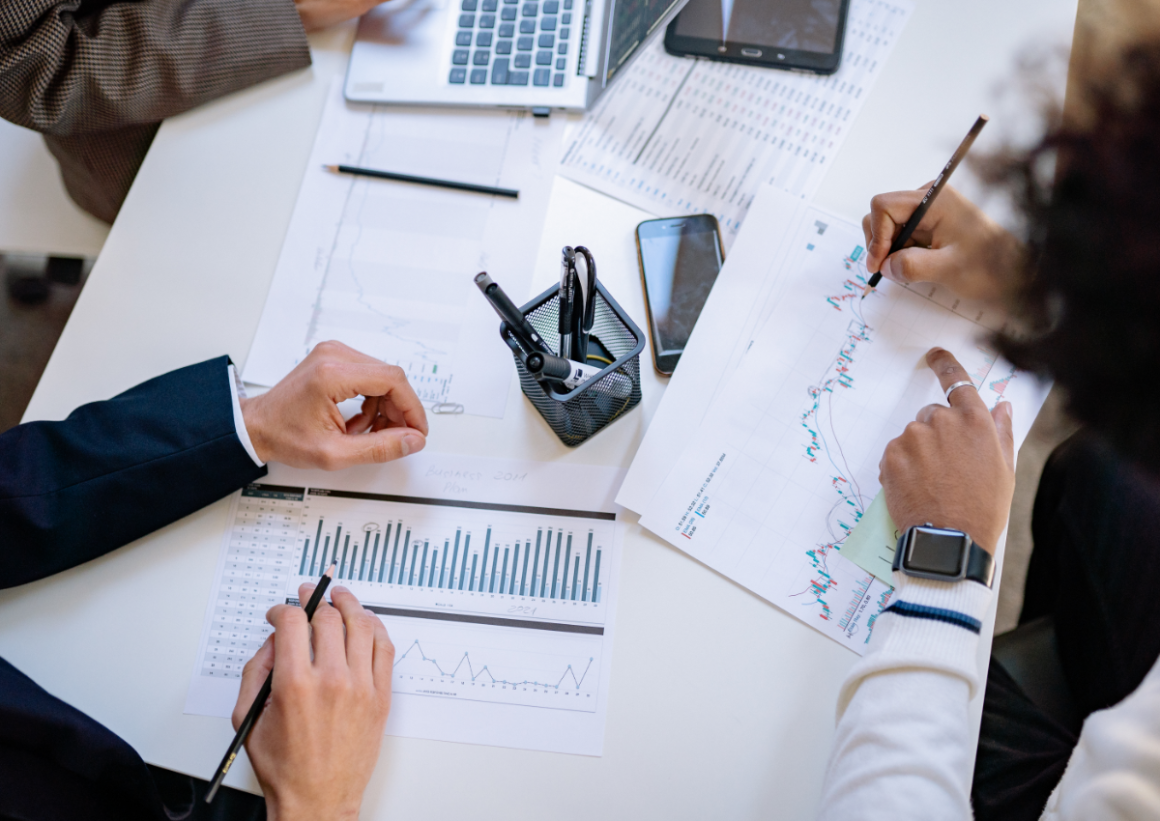 Overview of table with charts being studied and written on