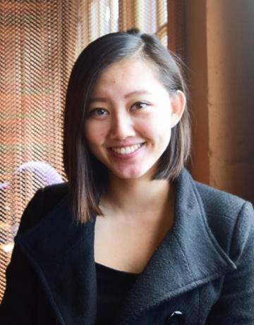 A person smiling in a professional setting.