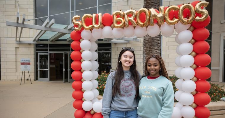 Leavey School of Business students in front of balloon display