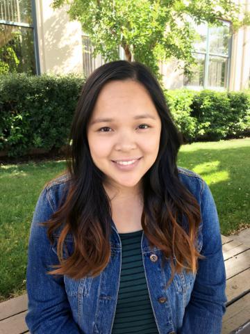 Person smiling outdoors, titled 'Vivian Vu -- Net Impact'.
