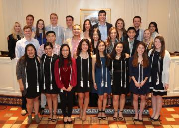 A group of well-dressed people posing together at the ACE 2018 Senior Dinner.