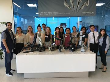 A group of people posed together indoors around a table.