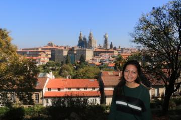 A person standing with Spanish cityscape in the background.