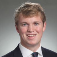A man in a suit and tie smiling.