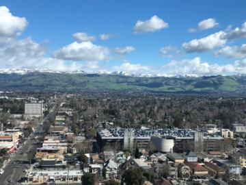 View of city buildings and distant mountains from the 17th floor of City Hall.