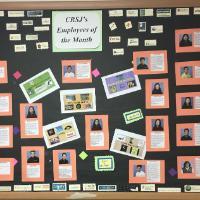 Bulletin board display with photos and notes titled 