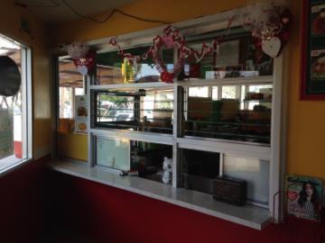 Front counter with computer screens and decorations at a business establishment.
