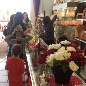 Alt text: People shopping inside Lucia's Imports store. Shelves filled with various items.