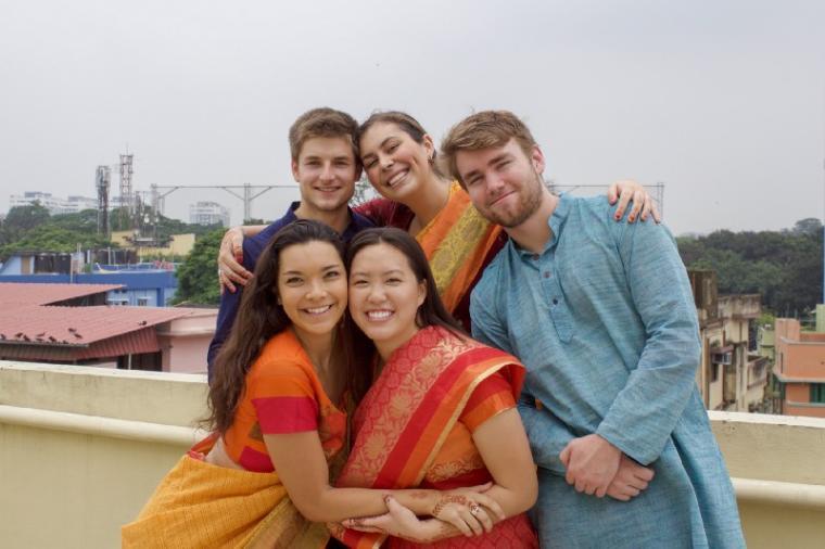 Five people smiling together outdoors in traditional Indian clothing. - Student Group Photo in India Link to file