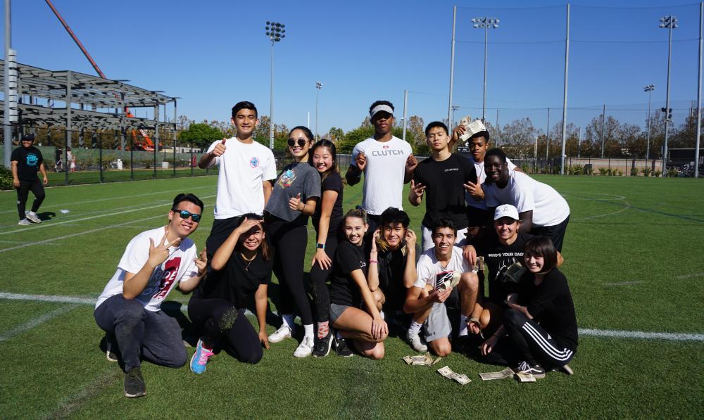 A group of people posing outdoors during a sports event.