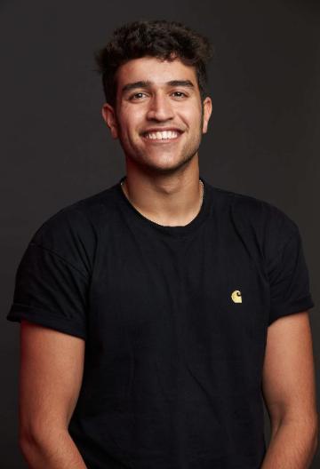 A person smiling, titled Aditya Chatrath, wearing a black shirt.