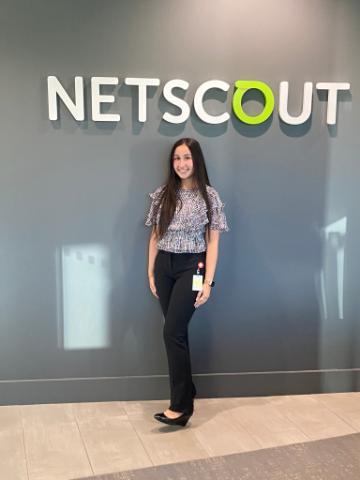 A person stands in front of a wall with a 