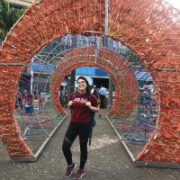 Person standing in front of Costa Rica-themed decorative archway.