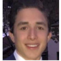 A person smiling in formal attire.