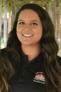 A person smiling outdoors, named Brittany Ricketts.