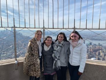Four people at a lookout point in New York City.