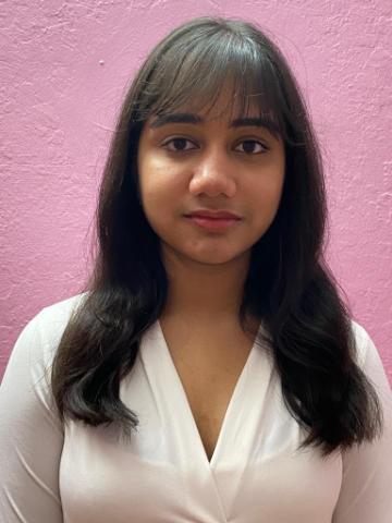 Headshot of a person against a pink background.