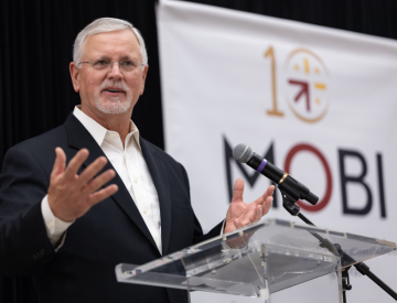 Photo of MOBI ED Drew Starbird speaking at 10th Anniversary