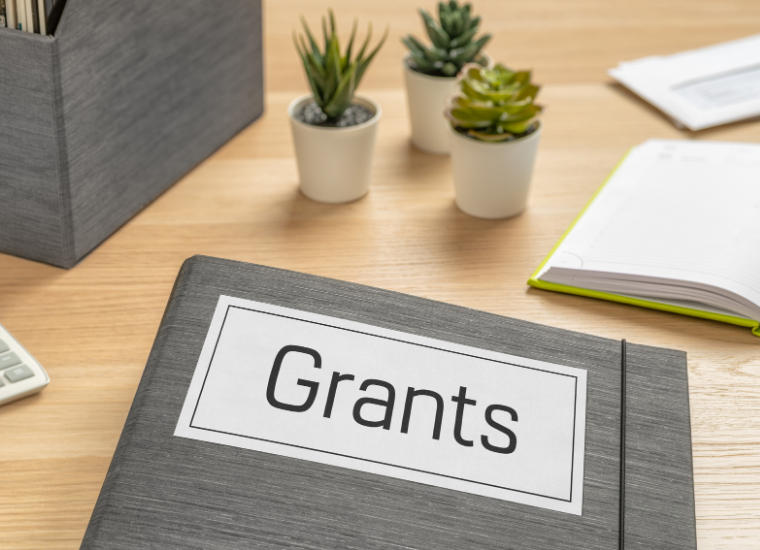 Photo of file folder with the word grants displayed