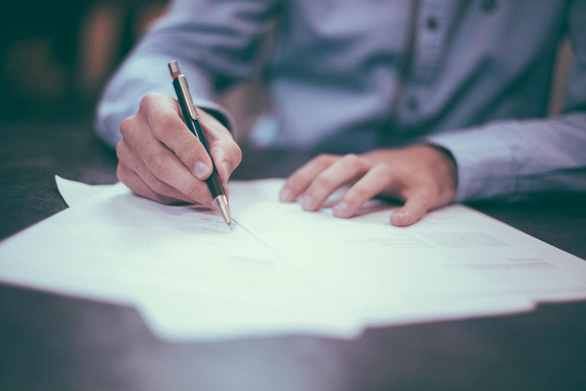 An entrepreneur sitting at a desk filling out paper work