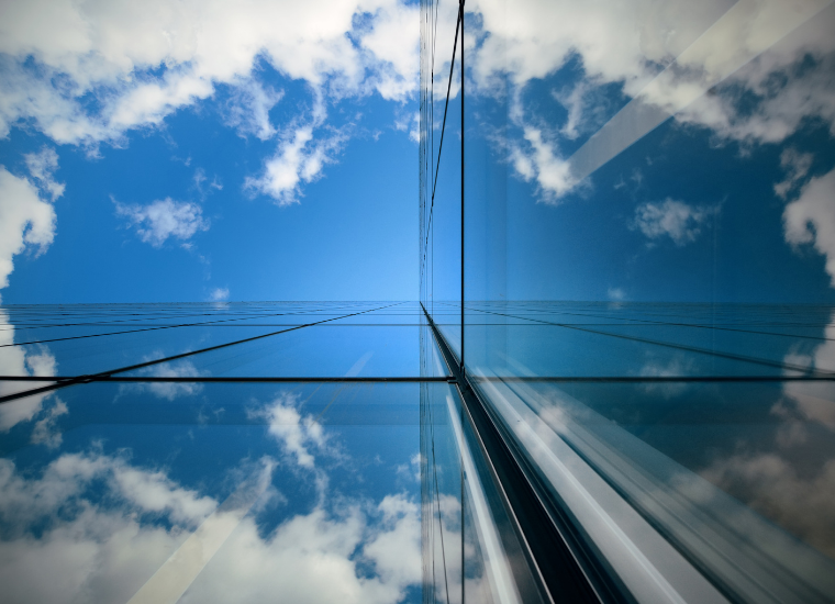 Photo of reflecting glass building and sky