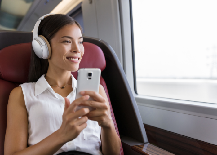Photo of commuter watching video with headphones