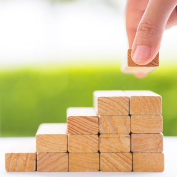 Photo of hand placing building blocks