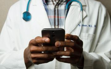 Healthcare worker looking at their mobile device 