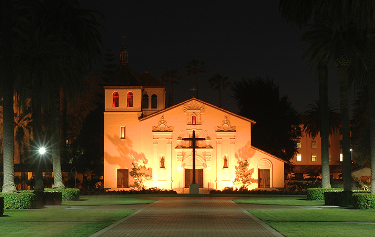 Palm drive leading up to the Mission Church at night. image link to story
