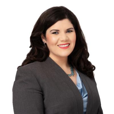 Headshot picture of Christina Bedolla; woman with dark hair and grey blazer