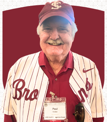 A smiling man in a Santa Clara University baseball cap and athletic shirt. His nametag reads 