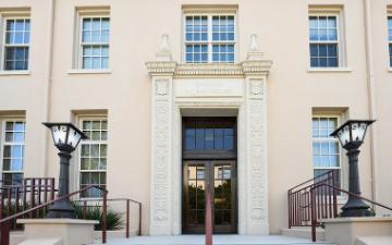 Exterior view of Bannan Alumni House entrance with lamps and steps
