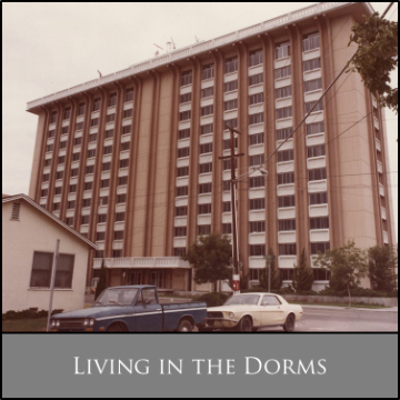 High-rise dormitory building with a low-rise structure in front; caption reads 