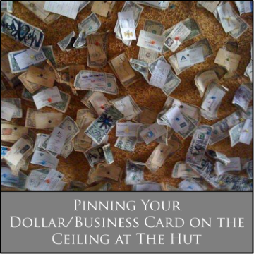 Dollar bills pinned to ceiling with text: 