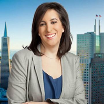 A woman in business attire stands in front of a city skyline.