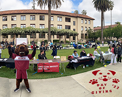 Bucky the Bronco celebrating Day of Giving.