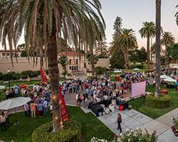 Alumni enjoying evening reception on the Abby Sobrato Mall.