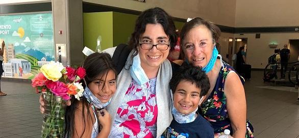 MaryAnn Dakkak, her son, daughter, and mother posing for a photo at their reunion.