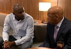 Lloyd Pierce and John Lewis sitting on a sofa.