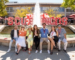 Friends and family seated in front of the Benson Fountain.