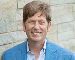 Man in a light blue sport coat.