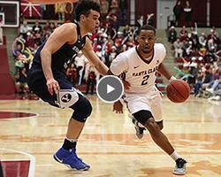 Action shot of men's basketball player driving to the basket.