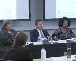 Four people sitting at a table for a panel discussion.